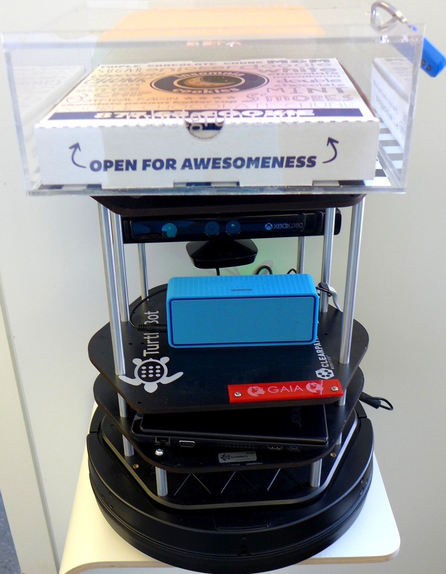 A small TurtleBot robot, kitted out with a cookie delivery box.